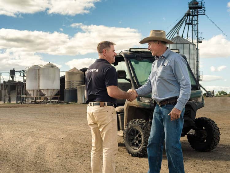 BOQ Senior Agribusiness Manager Ian Mills shakes hands with Barmount Feedlot co-owner, Phil Conaghan on site at Barmount Feedlot.